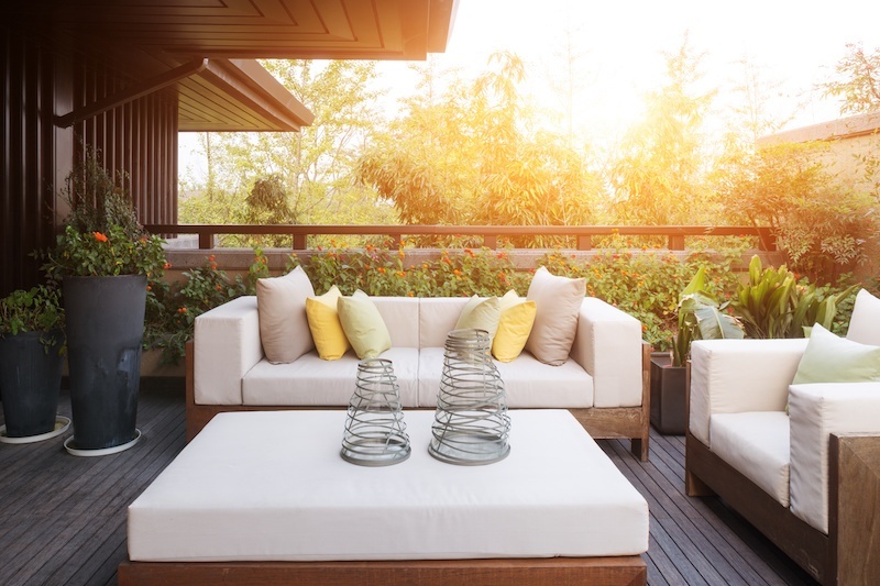 Porch with comfy outdoor furniture and plants