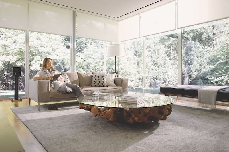 Living room with full-wall windows and shades