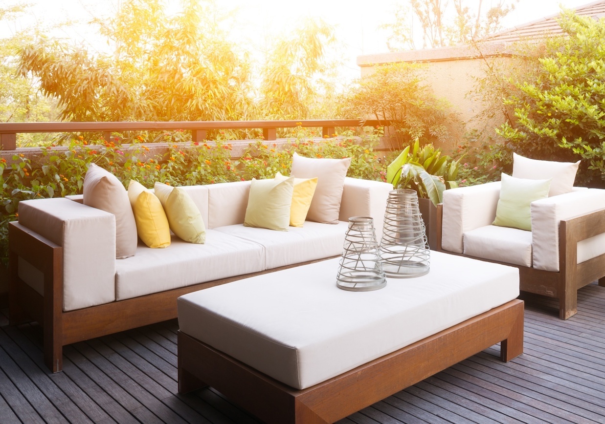 Porch with comfy outdoor furniture and plants
