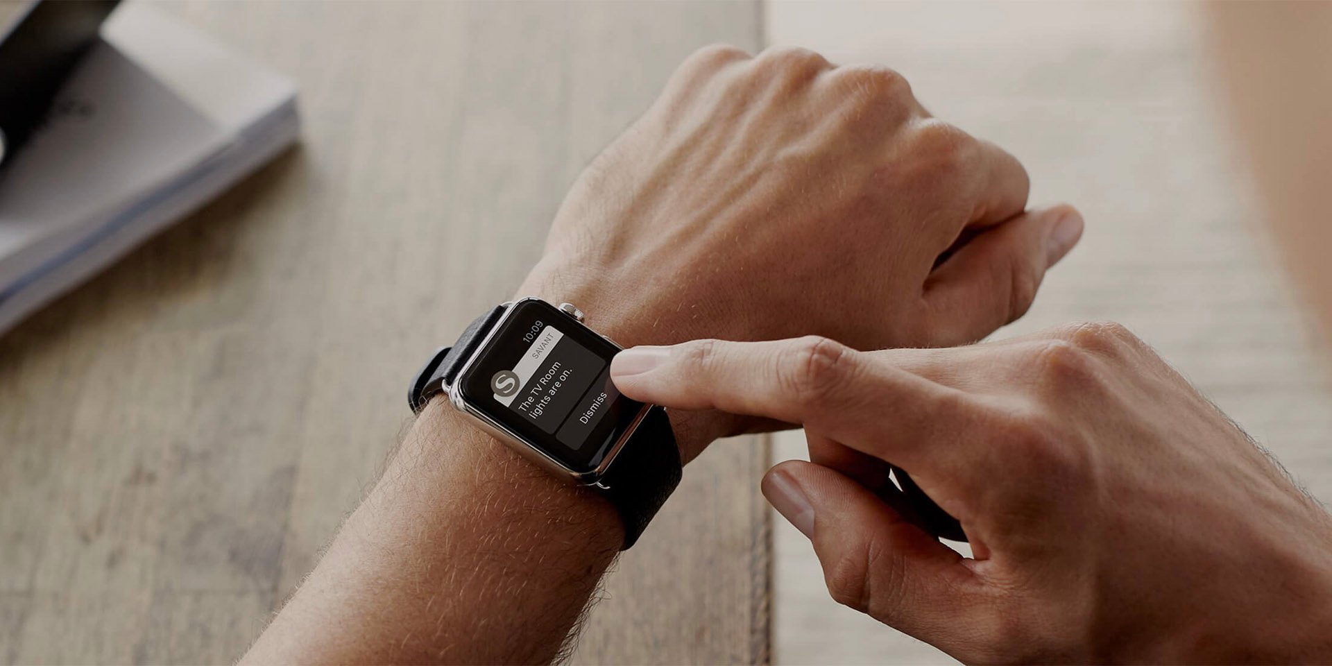 A man looking at his Savant controls on Apple Watch